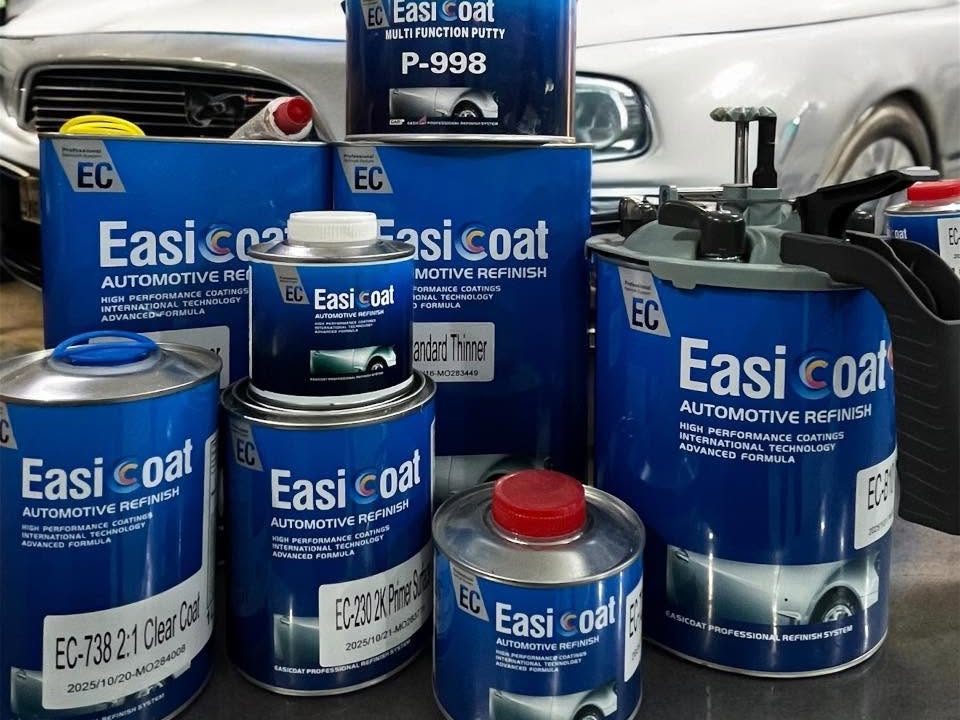 EasiCoat clearcoat, primer surfacer and multi function putty tins in front of a car